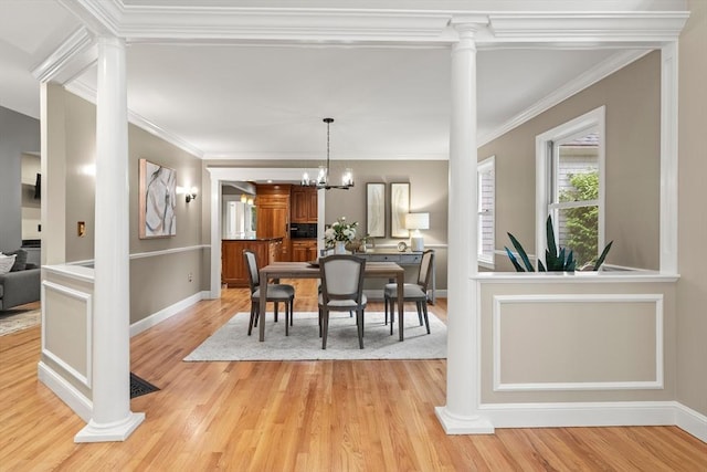 9 Twig Rush Ln, West Newbury, MA 01985 - dining area with ornate columns, light wood-style floors, crown molding, and a chandelier