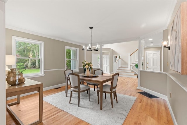 9 Twig Rush Ln, West Newbury, MA 01985 - dining room with ornamental molding, a chandelier, stairway, and light wood-style floors