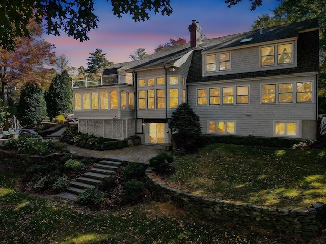 9 Twig Rush Ln, West Newbury, MA 01985 - back of house featuring a sunroom, stairs, a chimney, and roof with shingles