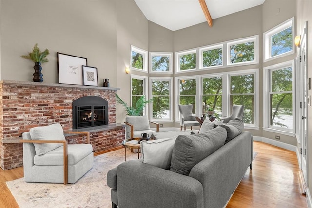 9 Twig Rush Ln, West Newbury, MA 01985 - living room with high vaulted ceiling, a fireplace, healthy amount of natural light, and wood finished floors