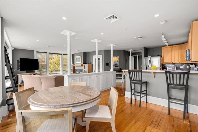 99 Washington St Unit 23, Salem, MA 01970 - dining area featuring decorative columns, light wood finished floors, and recessed lighting