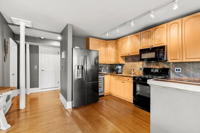 99 Washington St Unit 23, Salem, MA 01970 - kitchen featuring black appliances, light wood-type flooring, tasteful backsplash, and light brown cabinetry