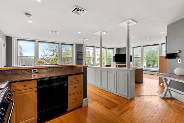 99 Washington St Unit 23, Salem, MA 01970 - kitchen featuring black dishwasher, stainless steel gas stove, light wood-style floors, ornate columns, and healthy amount of natural light