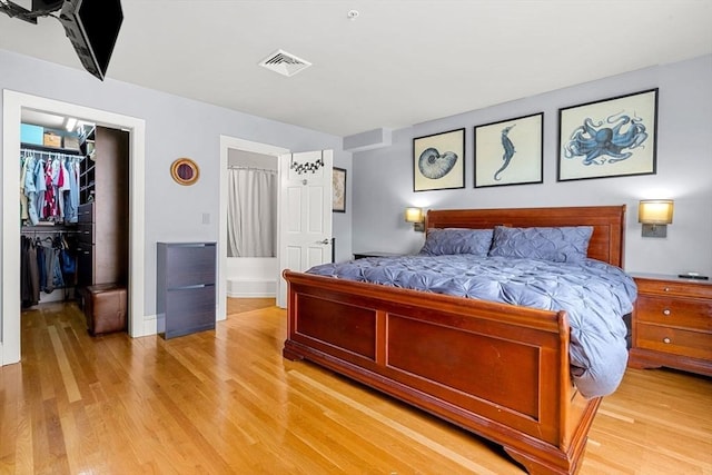 99 Washington St Unit 23, Salem, MA 01970 - bedroom featuring a spacious closet, light wood-style floors, a closet, and baseboards