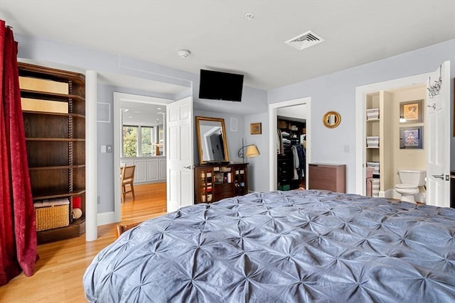 99 Washington St Unit 23, Salem, MA 01970 - bedroom featuring light wood finished floors, a spacious closet, a closet, and ensuite bathroom