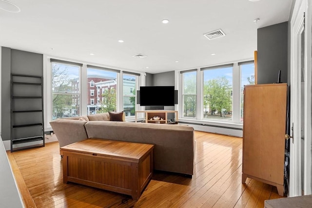 99 Washington St Unit 23, Salem, MA 01970 - living room with a baseboard radiator, light wood-style floors, and recessed lighting