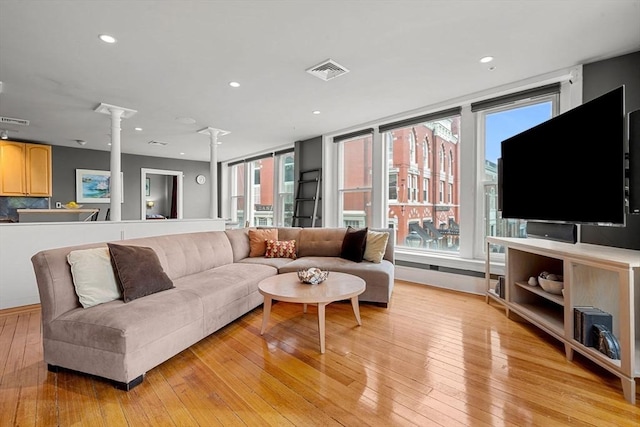 99 Washington St Unit 23, Salem, MA 01970 - living area with ornate columns, healthy amount of natural light, light wood finished floors, and recessed lighting