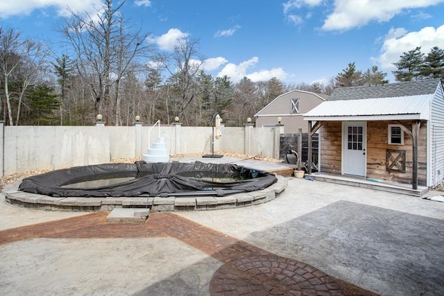 fenced backyard with a patio area and an outdoor structure