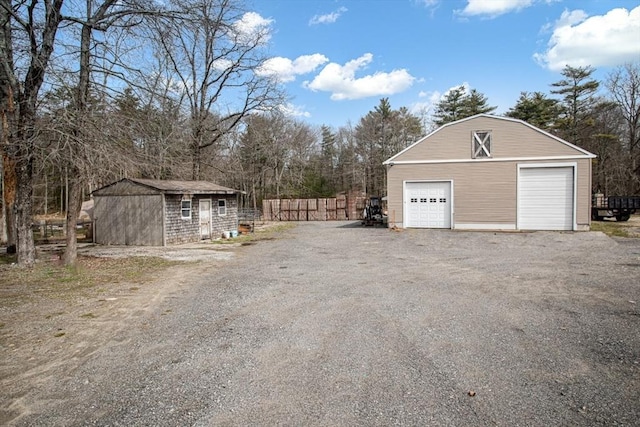 detached garage featuring fence