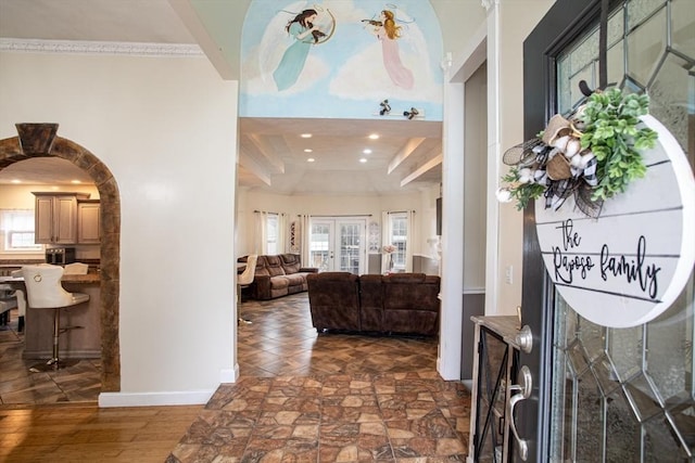 foyer entrance featuring baseboards, recessed lighting, and arched walkways
