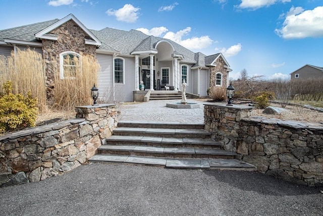 view of front of property with roof with shingles