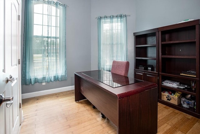 office area featuring light wood-style floors and baseboards