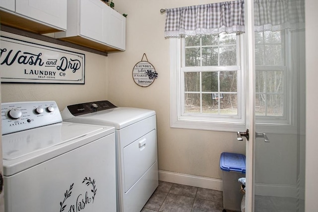 laundry room with cabinet space, independent washer and dryer, baseboards, and tile patterned floors