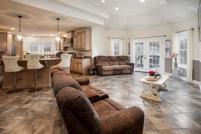 living room featuring recessed lighting, french doors, plenty of natural light, and baseboards