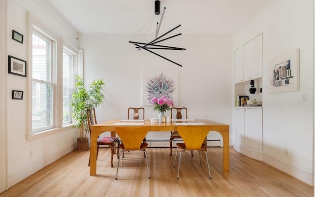 8 Oak St Unit 8, Cambridge, MA 02139 - dining room with light wood-style flooring, plenty of natural light, a chandelier, and crown molding