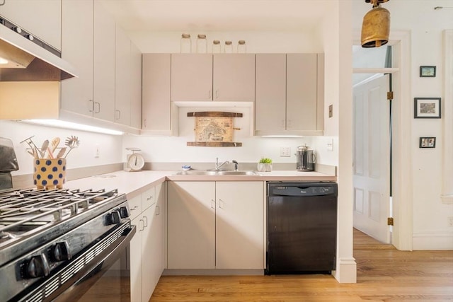 8 Oak St Unit 8, Cambridge, MA 02139 - kitchen featuring black appliances, under cabinet range hood, light wood-style floors, and light countertops