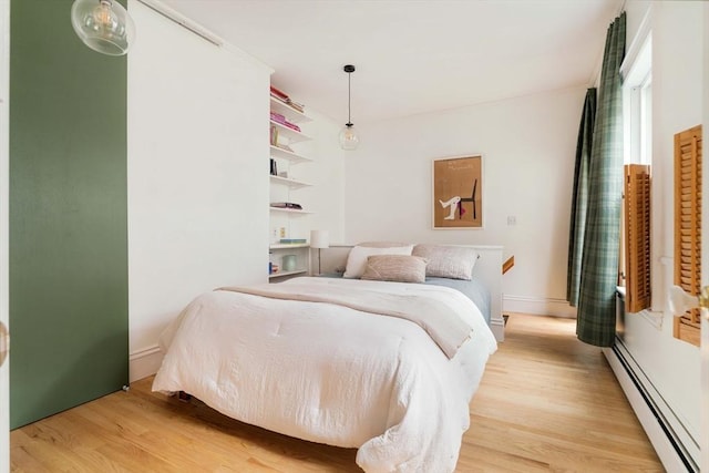 8 Oak St Unit 8, Cambridge, MA 02139 - bedroom with a baseboard heating unit and light wood-type flooring