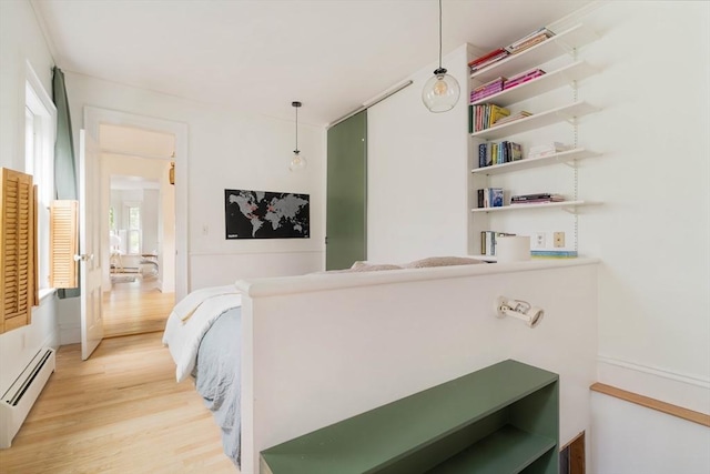 8 Oak St Unit 8, Cambridge, MA 02139 - bedroom with baseboard heating and light wood finished floors