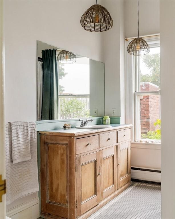 8 Oak St Unit 8, Cambridge, MA 02139 - bathroom featuring a baseboard heating unit, plenty of natural light, and vanity