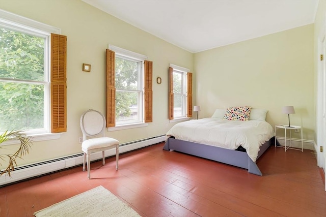 8 Oak St Unit 8, Cambridge, MA 02139 - bedroom with wood finished floors and a baseboard heating unit