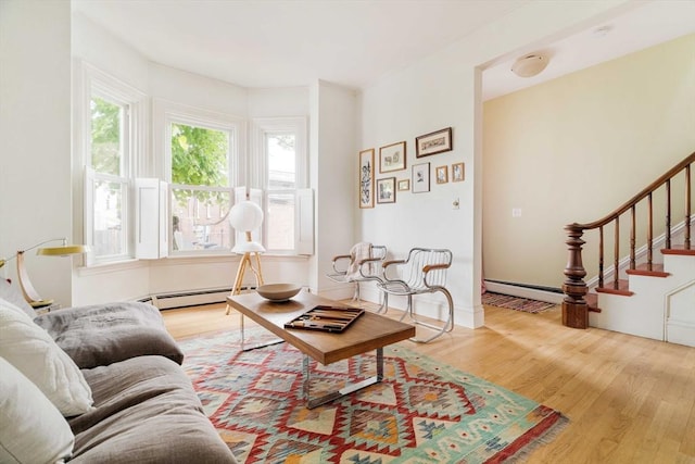 8 Oak St Unit 8, Cambridge, MA 02139 - living area with a baseboard heating unit, wood finished floors, and stairway