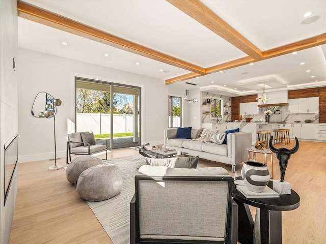 living room with light hardwood / wood-style flooring and beamed ceiling