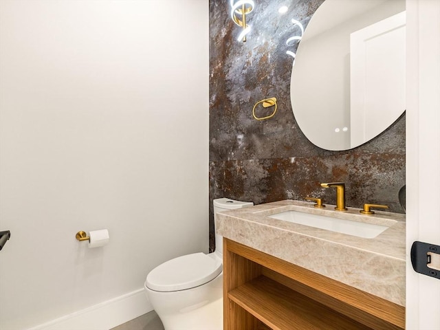 bathroom featuring decorative backsplash, toilet, and vanity