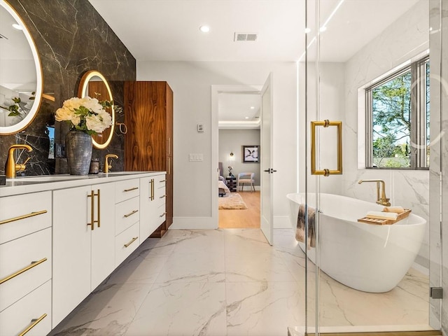 bathroom featuring a tub to relax in and vanity