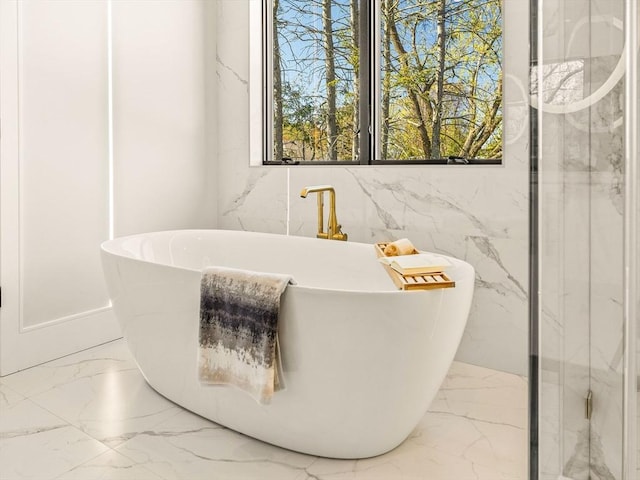 bathroom with a tub to relax in