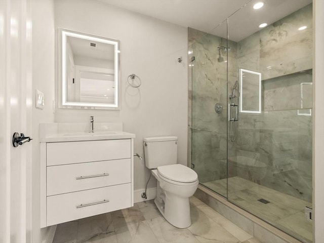 bathroom with toilet, vanity, and walk in shower