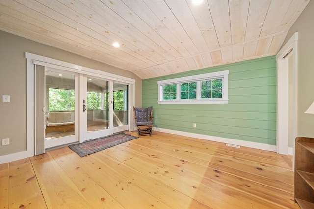 interior space featuring wood walls, plenty of natural light, lofted ceiling, and wood ceiling