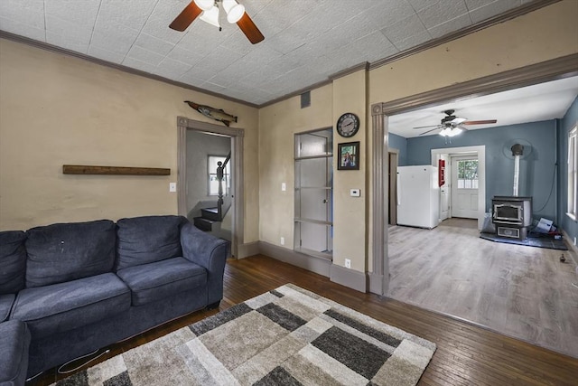 42 Briggs Ave, Pittsfield, MA 01201 - living room featuring a wood stove, a ceiling fan, crown molding, and hardwood / wood-style flooring