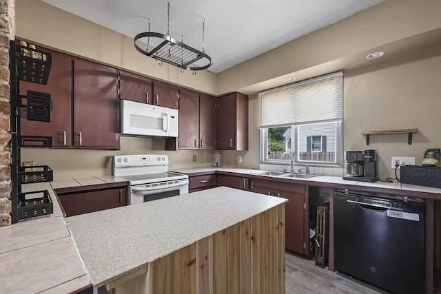 42 Briggs Ave, Pittsfield, MA 01201 - kitchen with white appliances, a sink, light countertops, a peninsula, and light wood-style floors