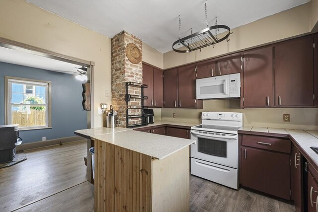 42 Briggs Ave, Pittsfield, MA 01201 - kitchen with white appliances, a peninsula, dark wood finished floors, and dark brown cabinetry