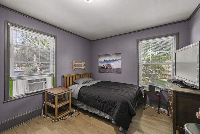 42 Briggs Ave, Pittsfield, MA 01201 - bedroom with multiple windows, light wood-style floors, cooling unit, and crown molding
