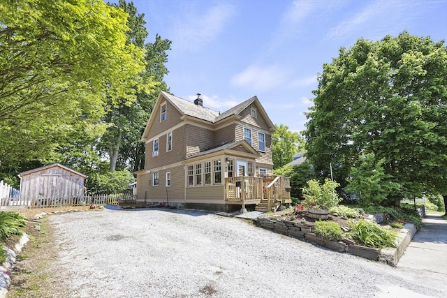 42 Briggs Ave, Pittsfield, MA 01201 - view of home's exterior with a wooden deck, a chimney, driveway, and an outdoor structure