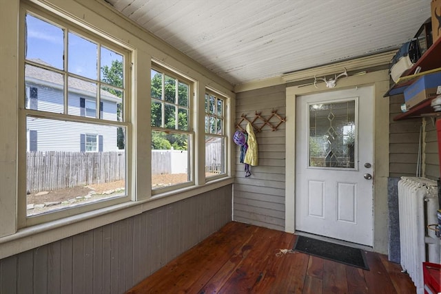 42 Briggs Ave, Pittsfield, MA 01201 - unfurnished sunroom with radiator heating unit, hardwood / wood-style floors, and wooden walls