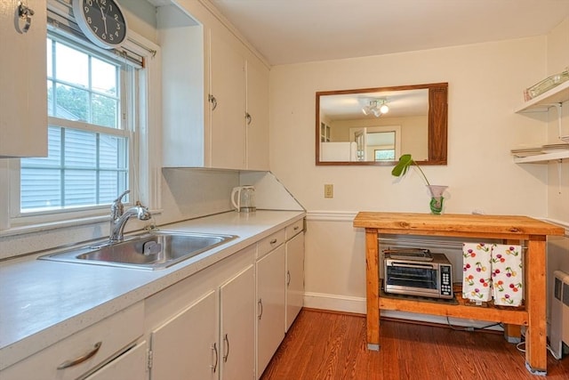 7 Broad St, Belmont, MA 02478 - kitchen featuring light countertops, light wood-style floors, and white cabinetry