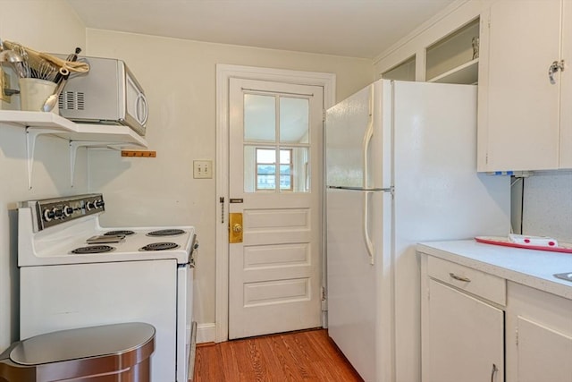 7 Broad St, Belmont, MA 02478 - kitchen with white appliances, light wood-style flooring, light countertops, open shelves, and white cabinetry