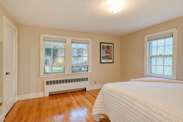 7 Broad St, Belmont, MA 02478 - bedroom featuring radiator heating unit and light wood finished floors