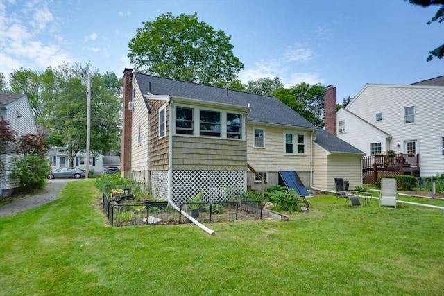 7 Broad St, Belmont, MA 02478 - back of house with a yard, a vegetable garden, a chimney, and a wooden deck