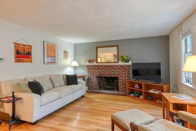 7 Broad St, Belmont, MA 02478 - living room featuring wood-type flooring, healthy amount of natural light, and a brick fireplace