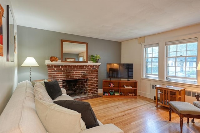 7 Broad St, Belmont, MA 02478 - living area featuring wood finished floors, radiator, and a fireplace