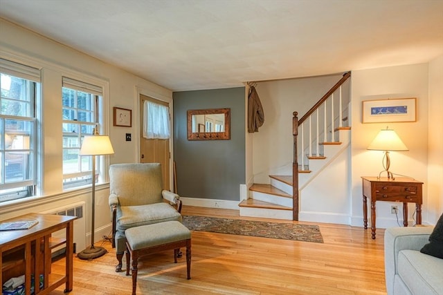 7 Broad St, Belmont, MA 02478 - sitting room with stairway, light wood finished floors, and radiator
