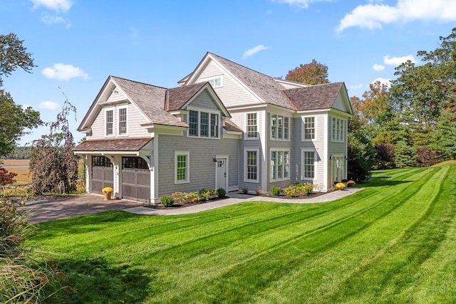 view of front of home featuring a front yard and a garage