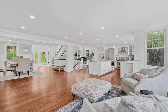 living room with crown molding, hardwood / wood-style flooring, and a wealth of natural light