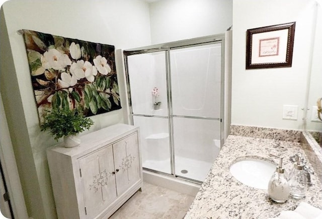 full bathroom with a shower stall and vanity