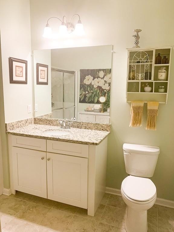 full bath with toilet, a shower stall, vanity, tile patterned flooring, and baseboards