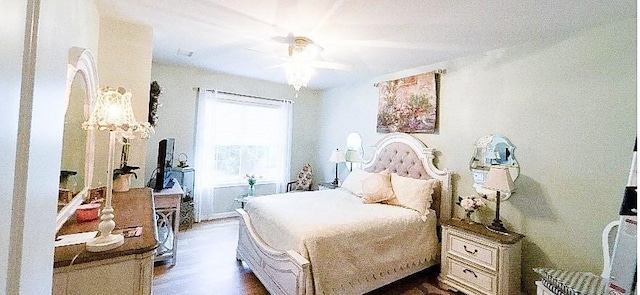 bedroom featuring dark wood-style flooring and ceiling fan