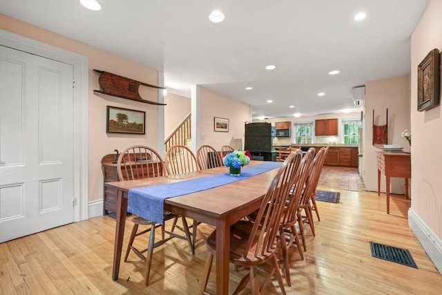 66 Rutland St, Boston, MA 02118 - dining space featuring light wood finished floors, stairway, and recessed lighting